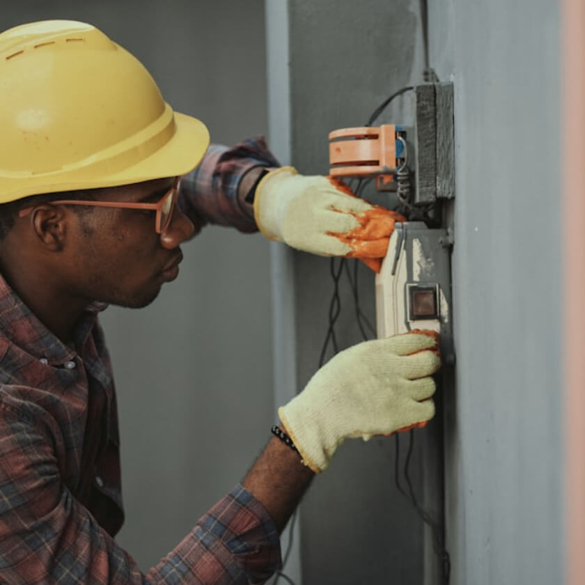 Technician fitting a split AC on a Setaflow installation visit